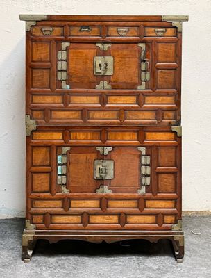 a wooden chest of drawers sitting on a concrete floor