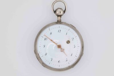 a silver pocket watch with a white face on a white surface