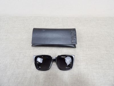 black sunglasses and a black case on a white surface