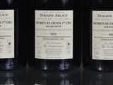 three bottles of wine sitting on top of a table next to each other