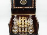 a wooden box with a set of glasses in it