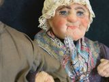 two dolls that are sitting next to each other