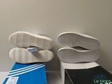 adidas shoes on a table next to a box and a pair of shoes