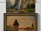 deux tableaux représentant un château et une cascade sur un mur blanc