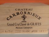 a wooden box that has a bottle of wine in it