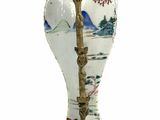 a white vase with a gold handle on a white background