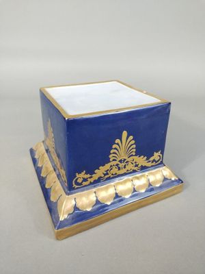 a blue and gold box with a gold decoration on it