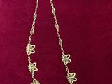 a gold necklace on a red velvet box