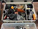 a box full of cameras and other items on a table
