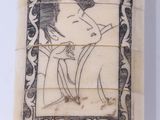 an antique chinese carved ivory box with a picture of a man