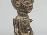 an image of a wooden cup shaped like a man holding a knife