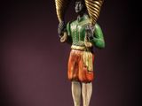 an image of a statue of a man holding two baskets on his head