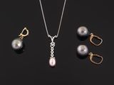 a necklace, earrings and ring with pearls on a black background