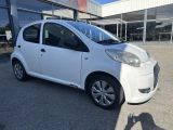 a white small car parked in front of a building