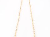 a gold necklace with pearls and a clasp on a white background
