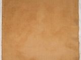 an old piece of brown paper hanging on a wall