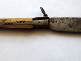 a knife that is laying on top of a table