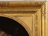 portrait of a man in a gold frame with a black background