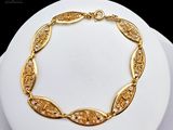 a picture of a gold plated bracelet on a mannequin