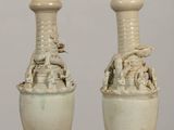 two vases that are sitting on a table