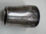 a silver cup that is sitting on a table