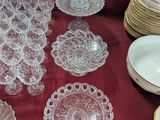 a table with a lot of glass plates and bowls on it