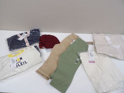 a lot of clothes that are on a white table