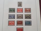 an open book with a bunch of stamps on it sitting on top of a table
