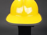 a yellow hard hat sitting on top of a black base