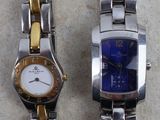 two watches sitting next to each other on a table