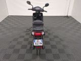 a motor scooter that is parked in a room