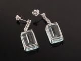 an image of a pair of earrings on a black surface