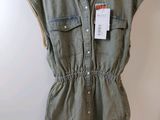 an image of a women ' s shirt dress hanging on a hanger