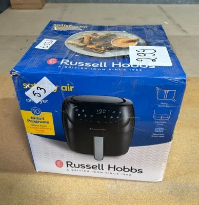 Friteuse à air chaud Russell Hobbs dans son emballage, posée sur une table