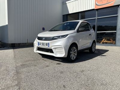 the white car is parked in front of a building