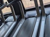 three tread machines are lined up in a row in a gym