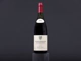 a bottle of wine sitting on top of a black table
