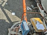 a small machine that is sitting on the side of the road