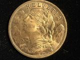 a close up of a gold coin with a woman ' s face on it