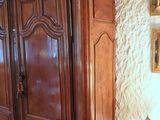 a large wooden cabinet in the corner of a room