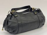 a black leather handbag on a white background