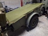 a military vehicle with a tarp on the back of it