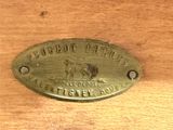 a brass plaque on a wooden table that says,