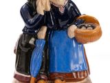 two figurines of two women sitting on a table