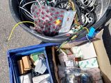 a bucket full of wires and other electronics in it