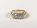 a close up of a gold and diamond ring on a white background
