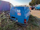 a blue van that is sitting in the grass
