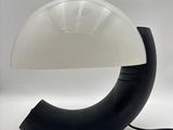 a black and white lamp that is on a table