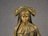a bronze statue of a woman holding a basket