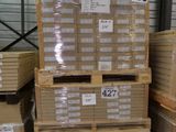 a large stack of boxes in a warehouse with price tags on them